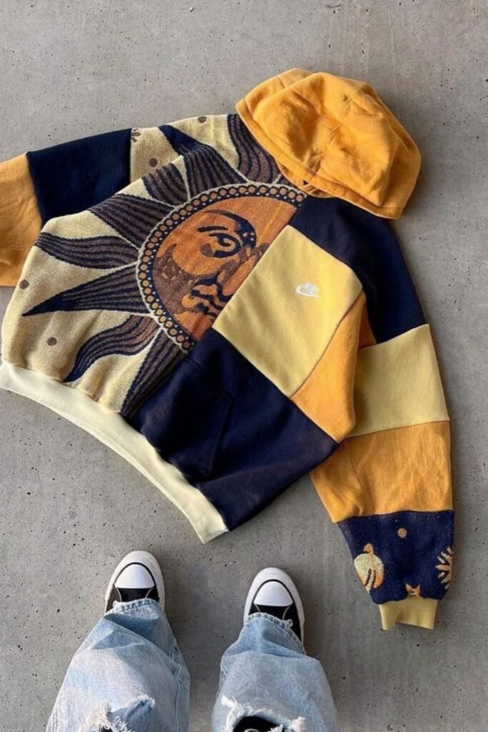 Reworked hoodie with a sun print panel and navy and yellow color blocks