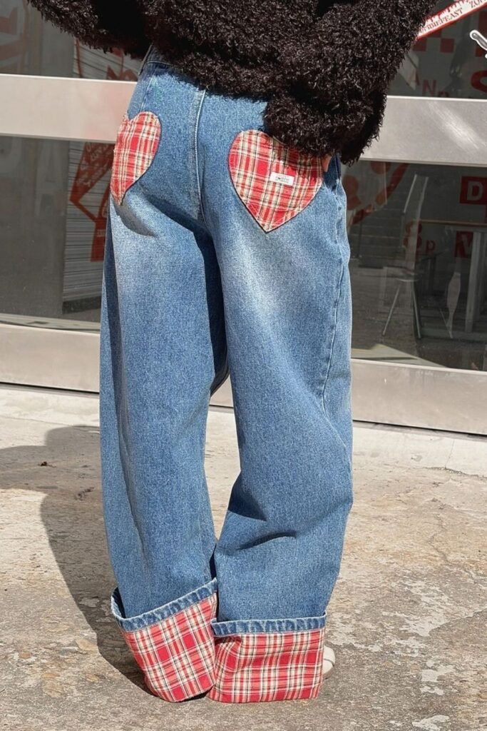 Upcycled jeans with red plaid heart patches on the back pockets and plaid cuffs