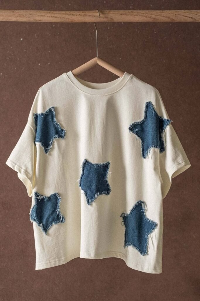 Cream oversized tee with frayed denim star patches