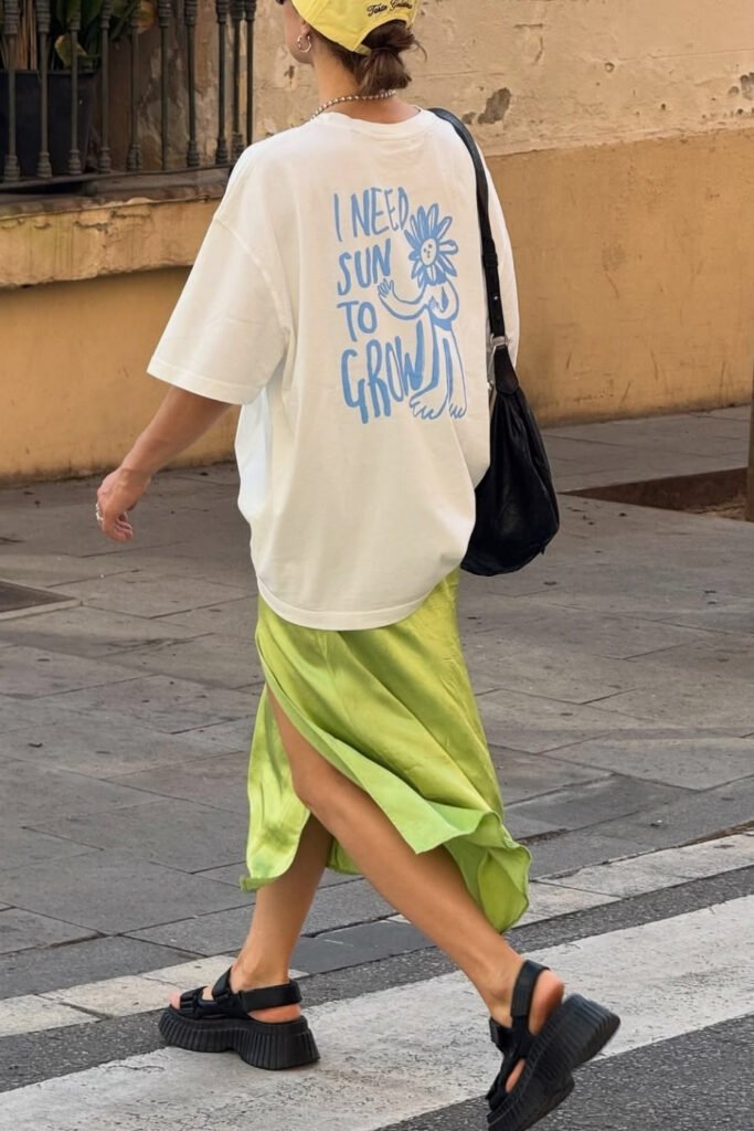White tee with a green satin skirt and sandals
