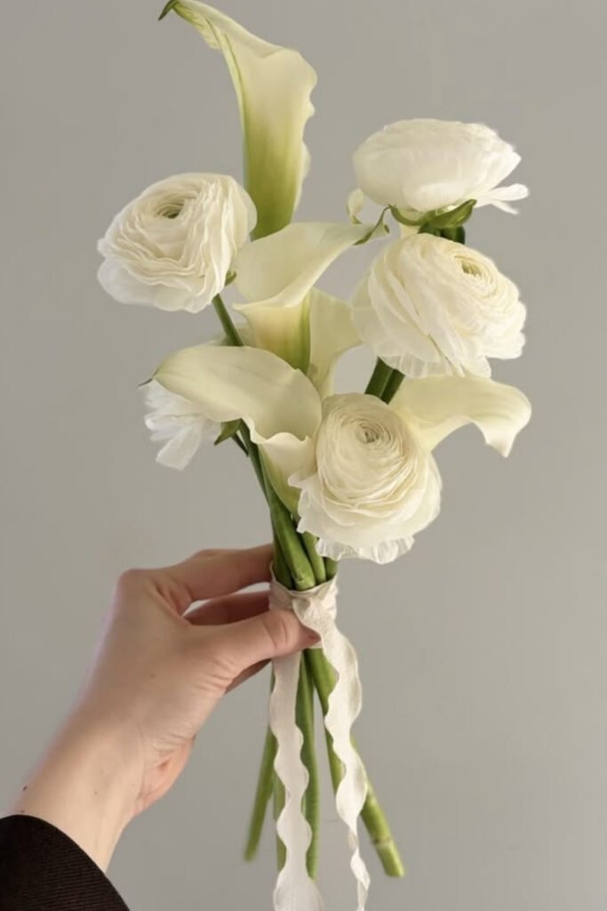 Small bridal bouquet of white calla lilies and white roses