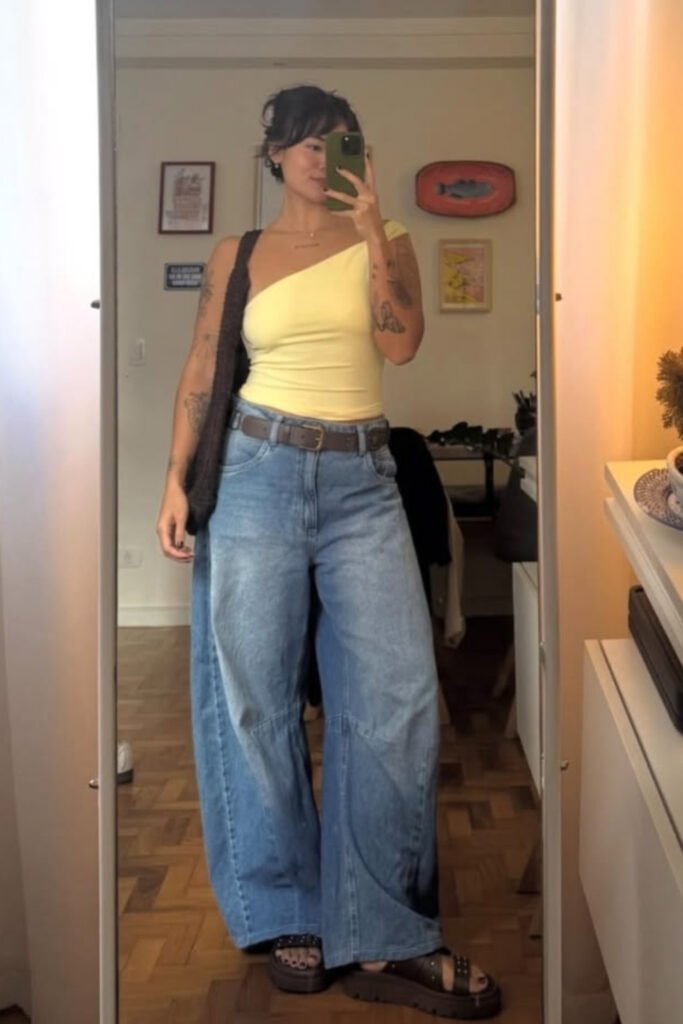 Cropped fitted yellow tank with low-slung barrel jeans