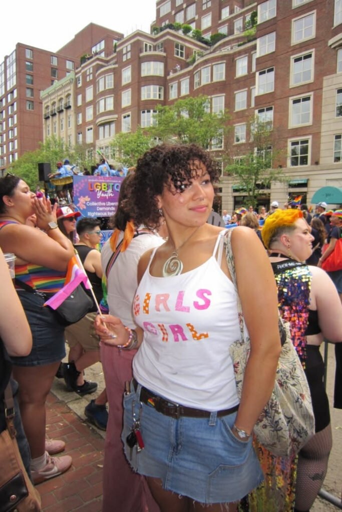 Slogan tank top and denim shorts in a Pride crowd