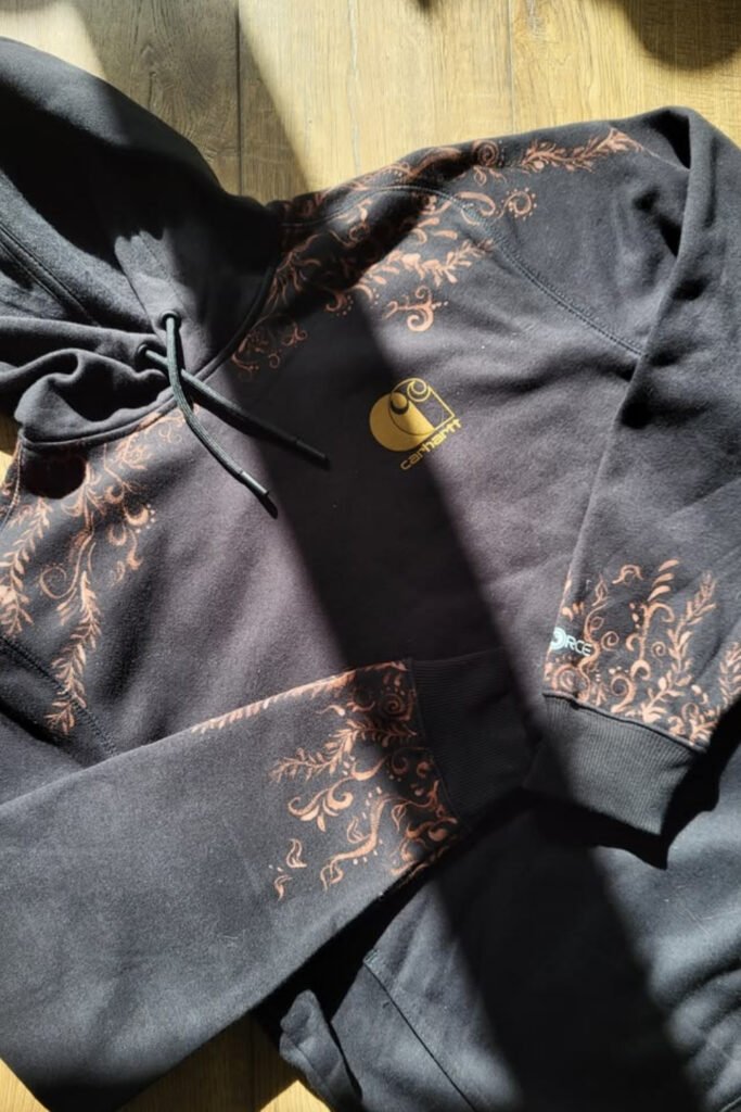 Black sweatshirt with subtle bleached details on the sleeves