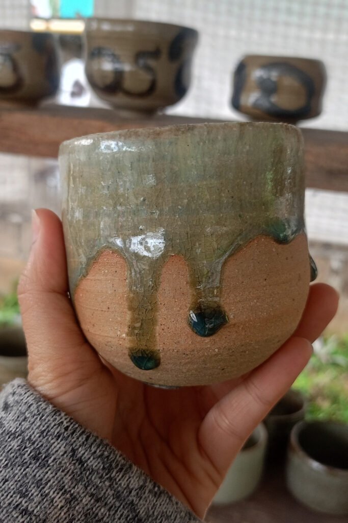 Ceramic cup with a soft drip glaze effect running down the sides