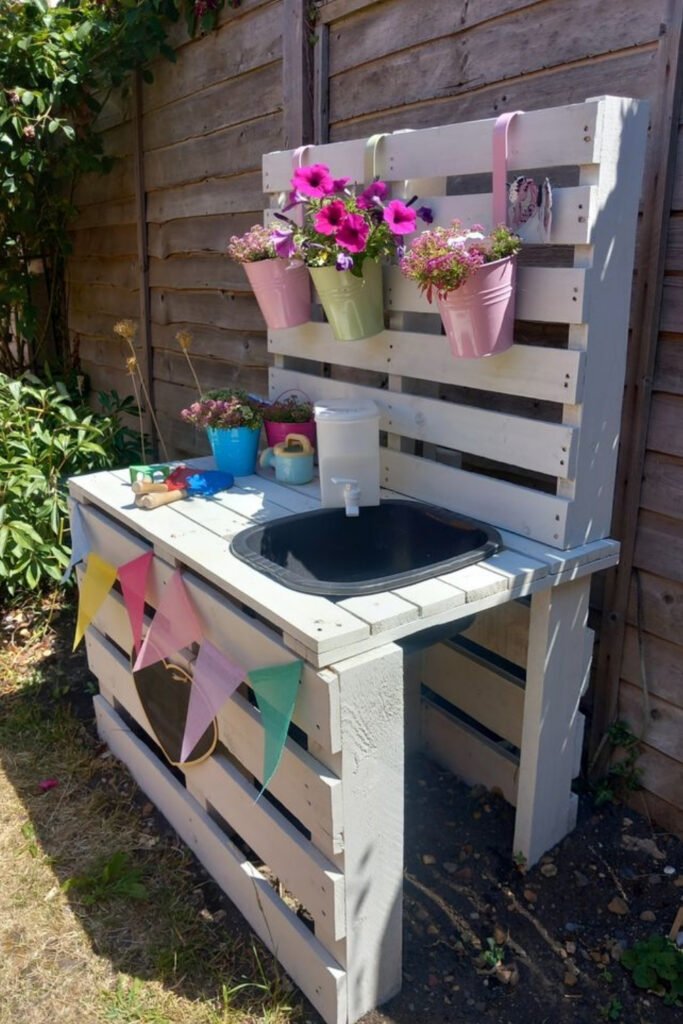 White pallet mud kitchen with a sink