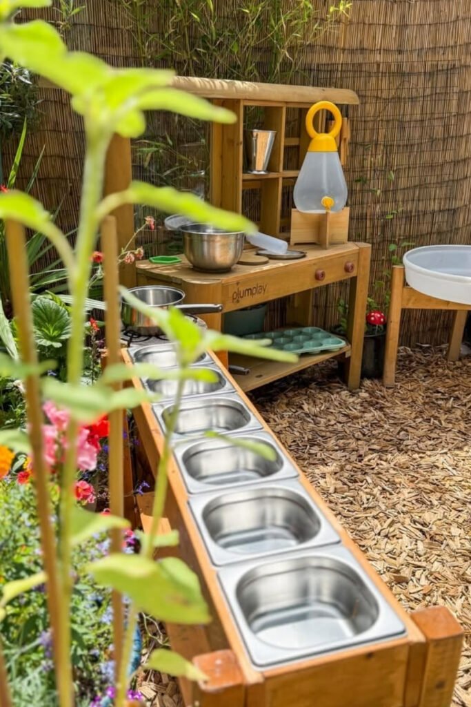 Long mud kitchen lined with bowls