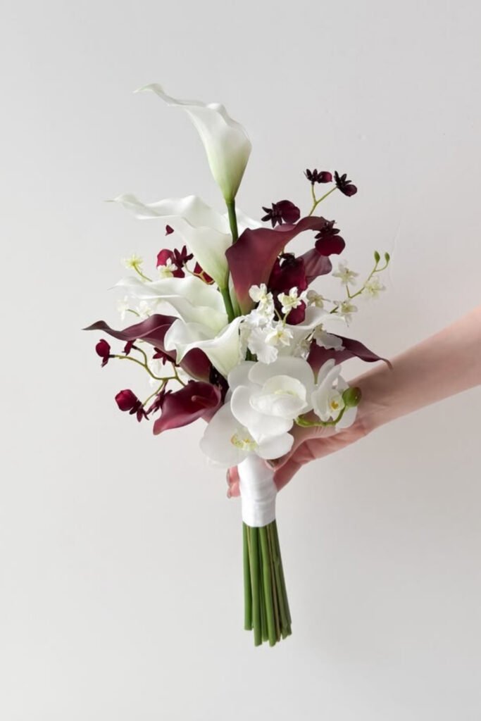 Small bridal bouquet of white and burgundy lilies