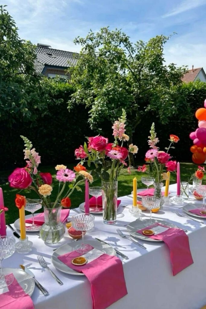 Long party table set with pink napkins