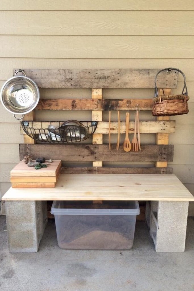 Pallet wall mud kitchen with hanging utensils