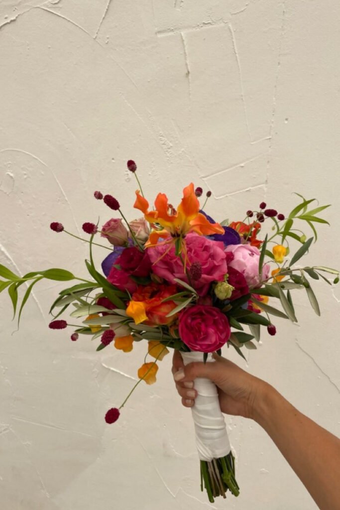 Bold red, orange and pink small bridal bouquet