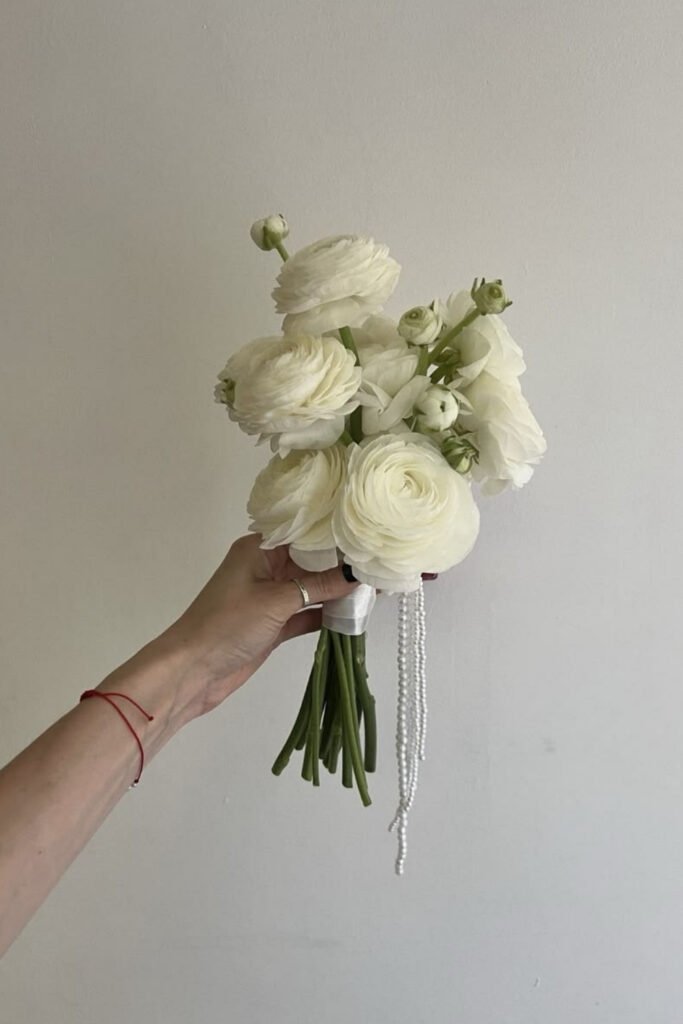 Small white ranunculus posy for a minimalist bride