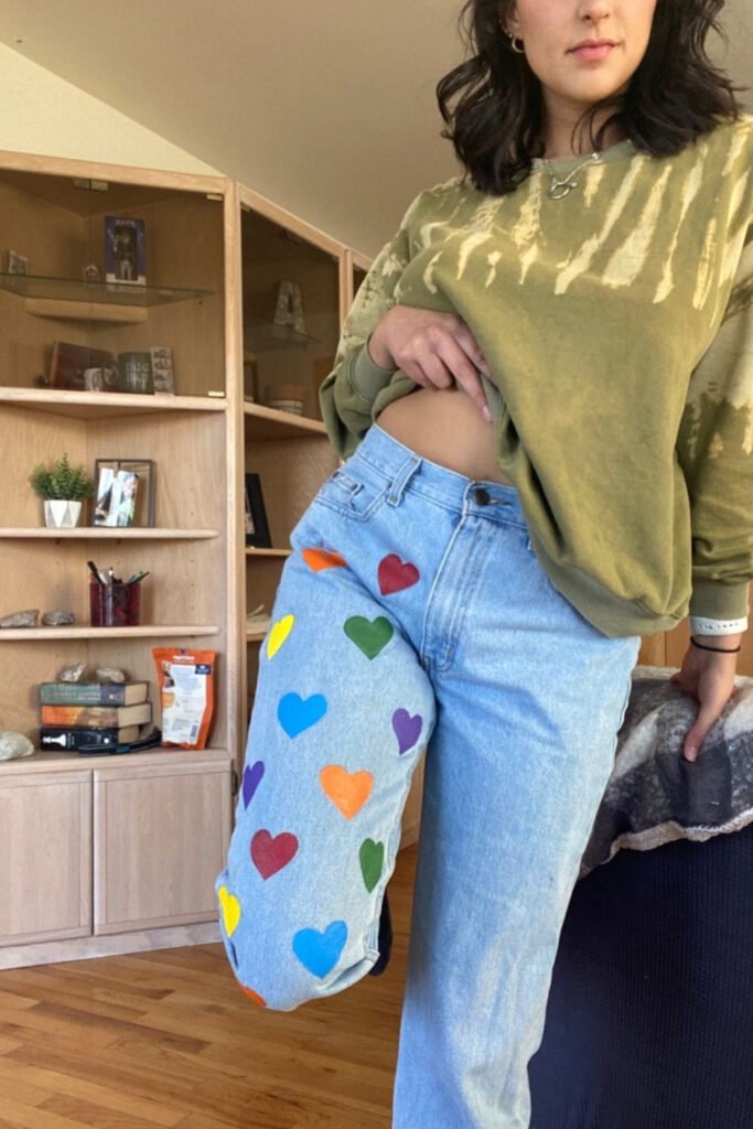 Light jeans hand-painted with colorful hearts down the leg