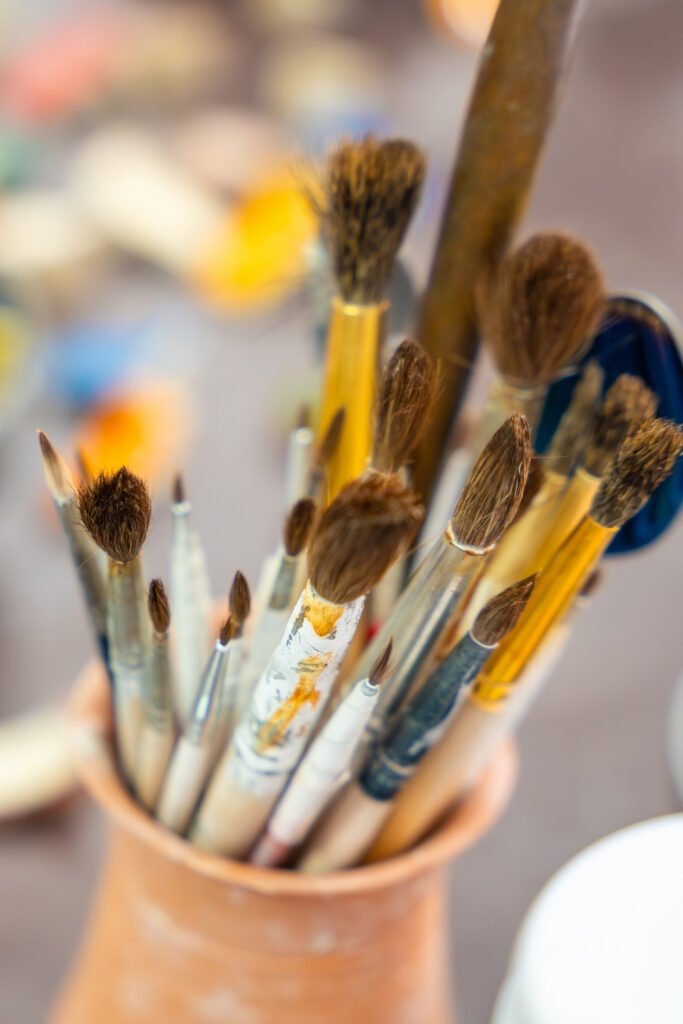 Paintbrushes of different sizes in a jar, ready for ceramic painting