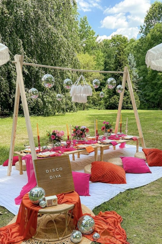 Outdoor picnic setup with pillows for a backyard graduation party