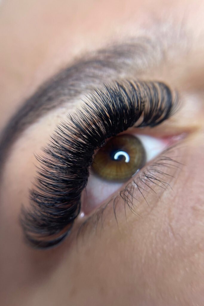 Close-up of full volume eyelash extensions on a brown eye