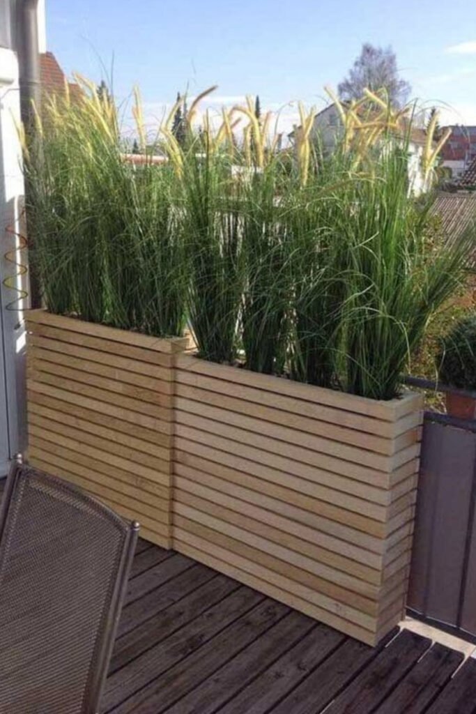 Wooden planter box screen with tall grasses